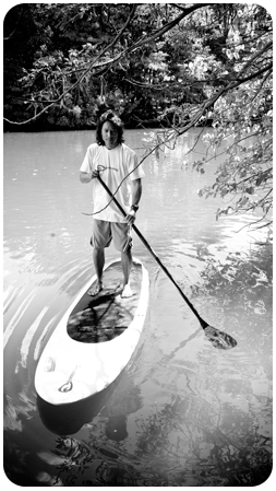 Kevin stand up paddling in Haleiwa